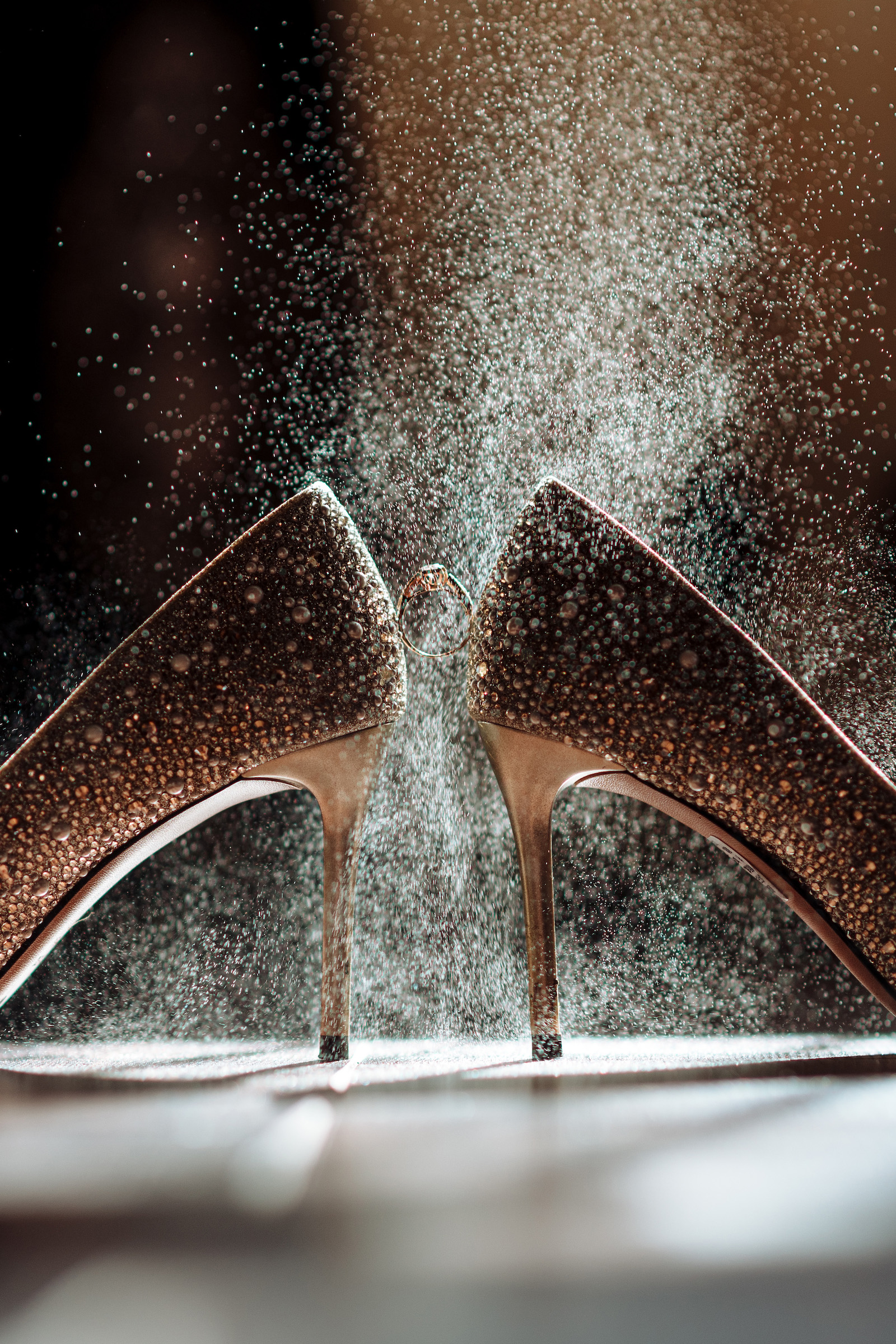 Wedding,Shoes,With,A,Wedding,Ring,Under,A,Splash,Of